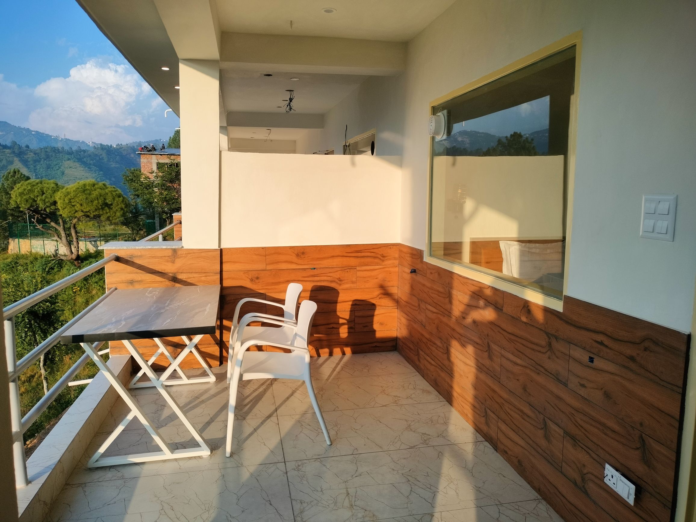 Corner balcony seating with valley and pine tree view